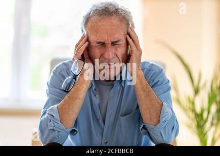 Senior man suffering from a headache Stock Photo