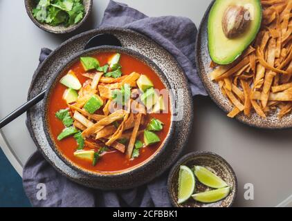 Mexican style table with spicy aztec soup with fried tortilla. Sopa azteca Stock Photo