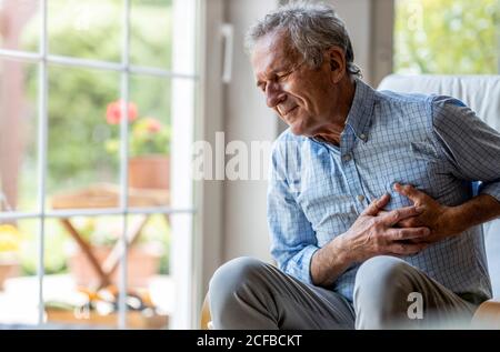 Senior man Suffering From Chest Pain Stock Photo