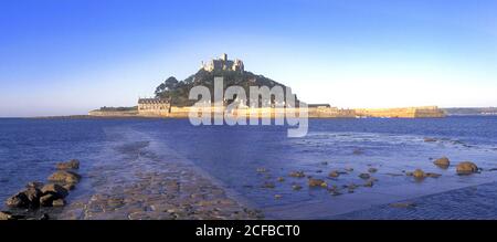 St Michaels Mount castle on a tidal island linked to mainland by man made causeway of granite setts visible at low tide Marazion Cornwall England UK Stock Photo