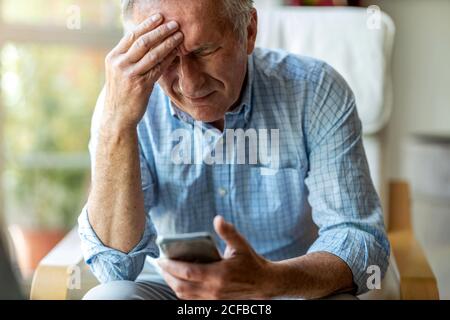 Senior man suffering from a headache Stock Photo