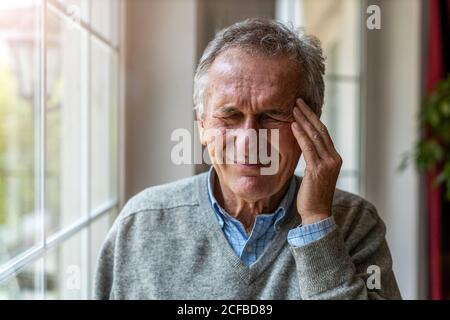 Senior man suffering from a headache Stock Photo