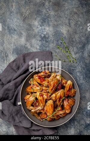 Roasted chicken wings in sweet sauce. Top view copy space Stock Photo