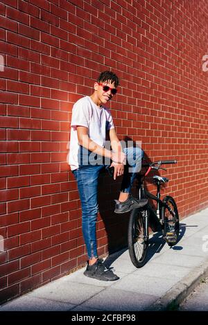 Young happy black male leaning on wall Stock Photo