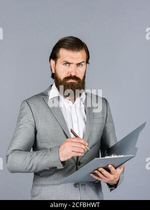 making notes. portrait of bearded man making notes. Confident businessman holding folder for documents. business people and corporate concept. caucasian businessman with folder at office. Stock Photo