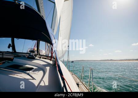 Modern motorboat floating on rippling sea water in sunny summer day with blue sky Stock Photo