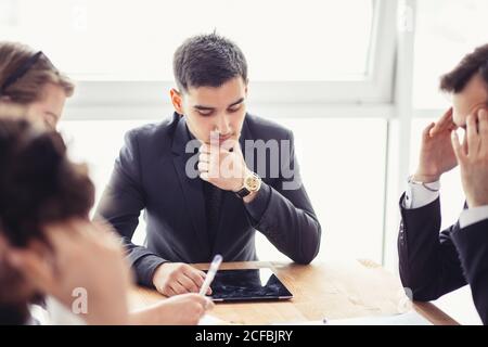 Team work process. young business managers crew working with new startup project. laptop on wood table, typing keyboard, texting message, analyse grap Stock Photo