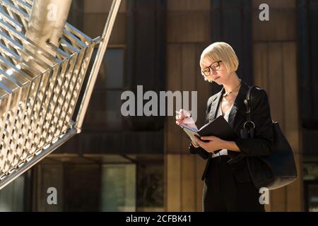 Stylish businessWoman writing on notebook Stock Photo