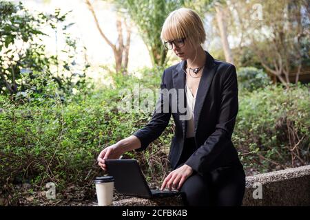 Young businessWoman sitting and using tablet Stock Photo