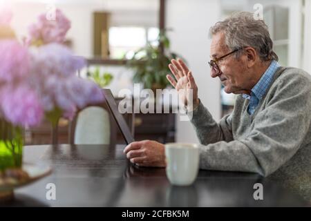 Senior man using laptop at home Stock Photo