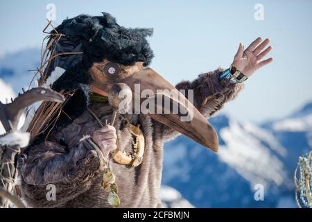 First Nations person dressed in Ravens mask preforms a ceremony Stock ...