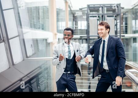 Two multiethnic male employees consulting in office Stock Photo