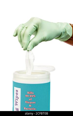 Vertical close up shot of a rubber gloved hand pulling up on a disinfectant wipe. Stock Photo