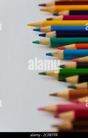 Close up of new colored pencil crayons on white background. Stock Photo