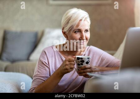 Mature woman using laptop at home Stock Photo