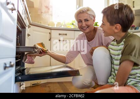 Mother teaching her son how to bake Stock Photo