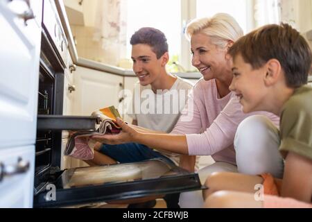 Mother teaching her son how to bake Stock Photo
