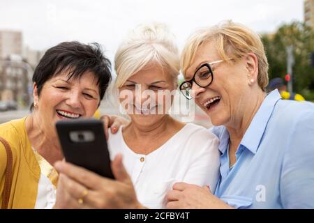 Group of senior women using smartphones together Stock Photo
