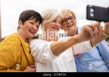 Group of senior women using smartphones together Stock Photo
