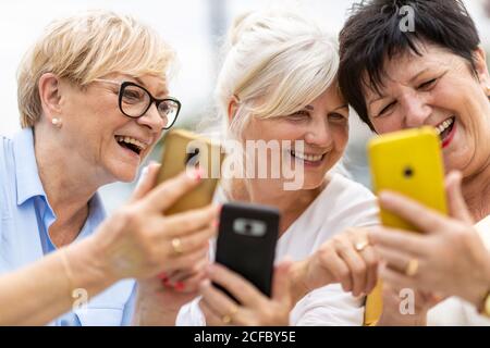 Group of senior women using smartphones together Stock Photo