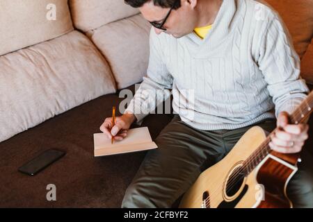 Musician writing in a notebook Stock Photo