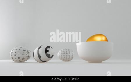 Golden egg on a bowl among painted and decorated easter eggs on white background Stock Photo