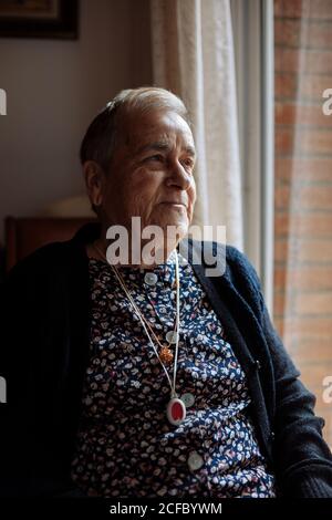 Elderly Woman with personal alarm hanging from the neck Stock Photo