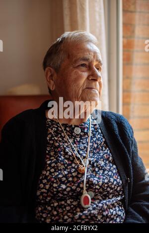 Elderly Woman with personal alarm hanging from the neck Stock Photo
