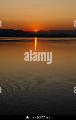 Intense colors of a sunset with reflections in the water Stock Photo