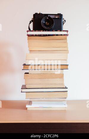 Vintage camera on top of a stack of books Stock Photo