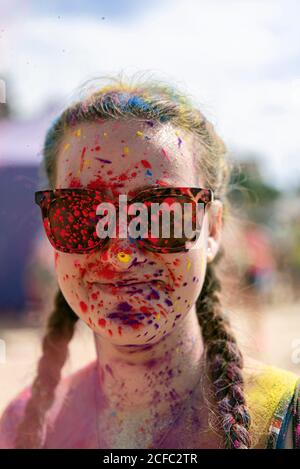 A man with sunglasses and holi paint on his face · Free Stock Photo