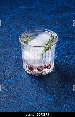 Fresh ice cold carbonated water drink in glass on blue textured background, angle view Stock Photo
