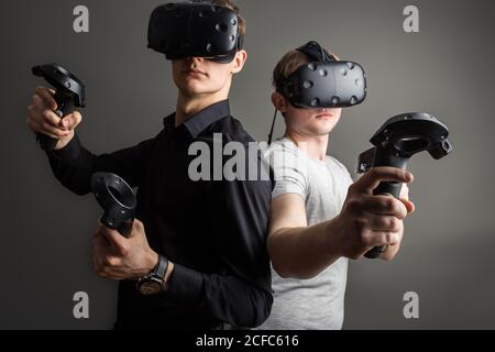two young man playing game using virtual reality headset Stock Photo
