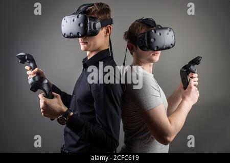 Cheerful friends are watching modern headset Stock Photo