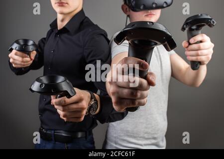 Cheerful friends are watching modern headset Stock Photo
