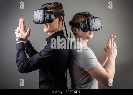 Cheerful friends are watching modern headset Stock Photo