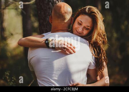 Happy couple embraced in forest