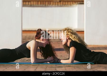 Slim women doing plank pose during yoga practice Stock Photo