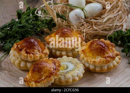 Appetizer made of quail eggs inside puff pastry, perfect for holidays like Easter, Halloween or even Christmas Stock Photo