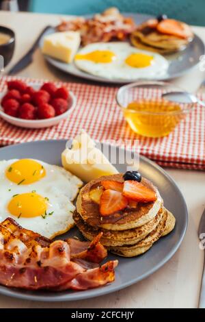 Delicious fried eggs with bacon and cheese for breakfast Stock Photo