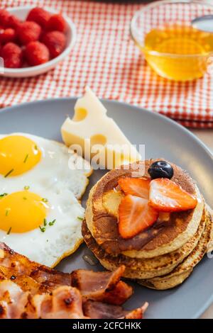 Delicious fried eggs with bacon and cheese for breakfast Stock Photo