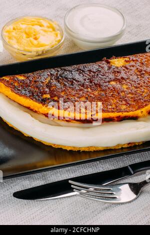 Cachapa, typical Venezuelan dish made with corn and stuffed with white cheese Stock Photo