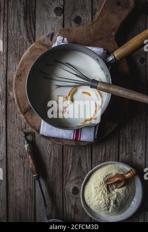 From above baking dish with corn flour for cooking on cutting board on wooden background Stock Photo