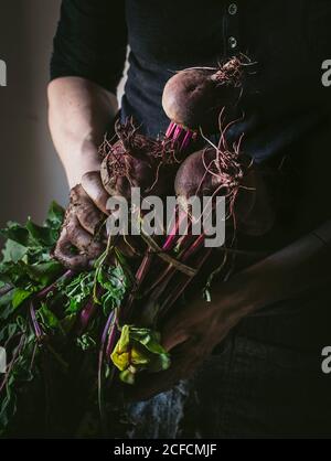 faceless person with bunch of beetroots and key Stock Photo