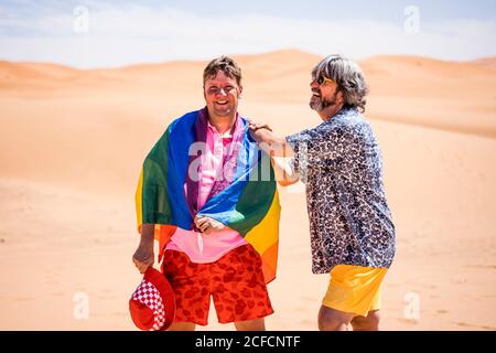 Excited plump gay couple in desert Stock Photo