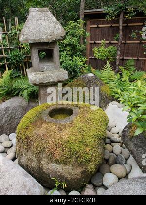 From above of old construction with big stones covered with green moss in aged beautiful garden in Japan Stock Photo