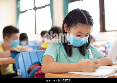 students wearing  mask and  studying in the classroom. Stock Photo