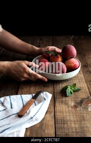Tasty ripe peaches in plate Stock Photo
