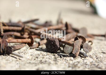 Rusty, pointy, and potentially painful nails laying on the ground. Stock Photo