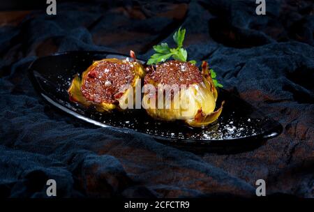 Tasty stuffed artichokes with salt on black background Stock Photo